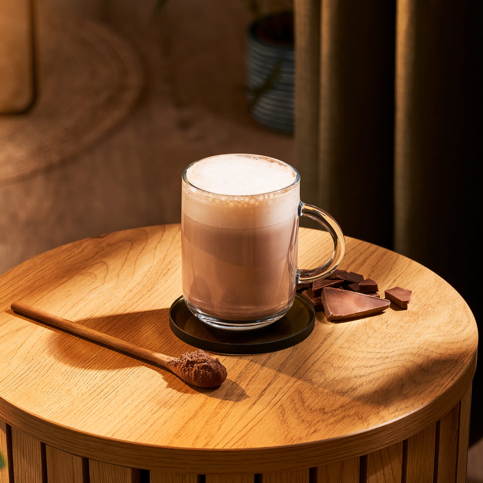 Hot cup of chocolate milk on a coffee table